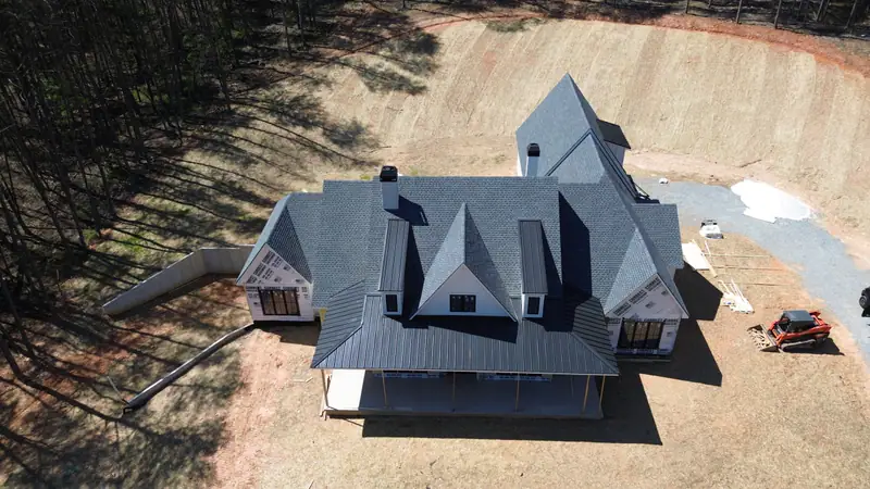 New construction home with steep gables and a freshly installed architectural shingle roof